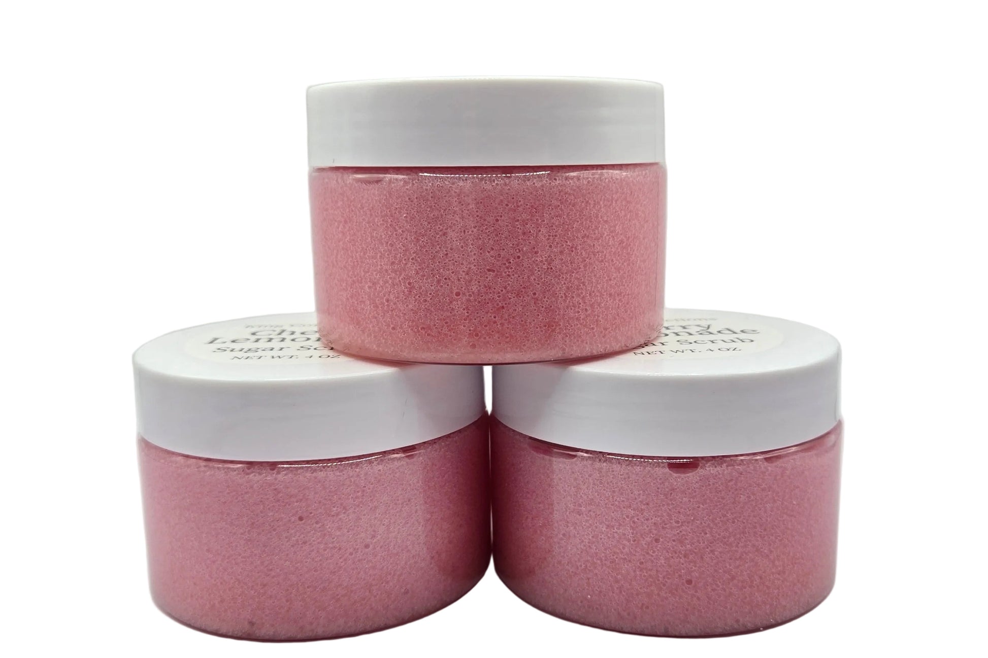 Three pink jars with white lids.